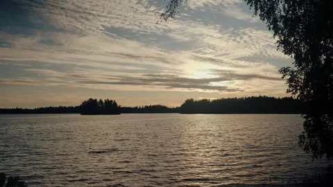 Tranquil Clouds and Reflections Over Finnish Lake at Sunset Stock Footage 346897263