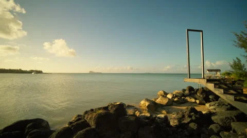 A tranquil coastal scene with a dock, boat, and serene nature Stock Footage 313824532