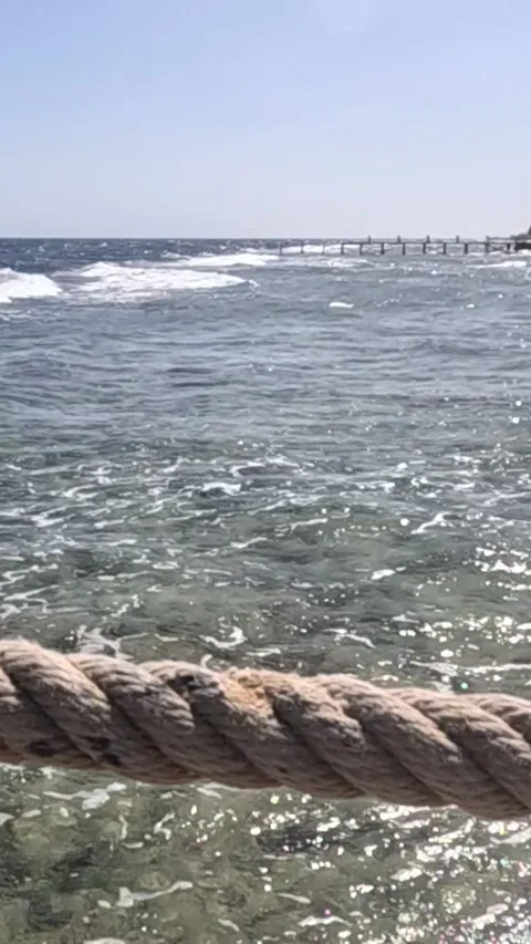 Tranquil Coastal Scene Featuring Clear Waters and Gentle Waves with a Prominent Video stock 330095605