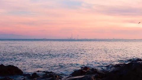 Tranquil Coastal Scene with Small Waves and a Cruise Ship Passing Poolbeg Stock Footage 334671917