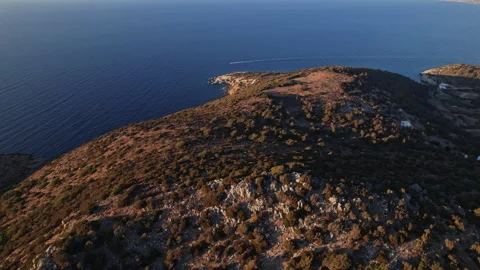 Tranquil coastal sunset view over a rocky shoreline Stock Footage 290088275