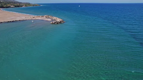 Tranquil coastal view with sandy beach and calm blue waters Stock Footage 290083495