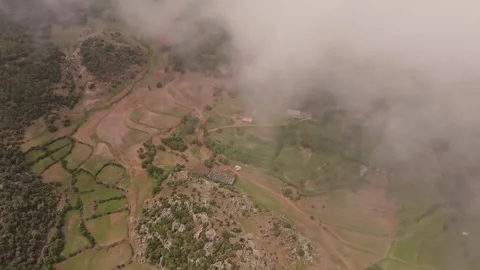 Tranquil countryside with fields, paths, and a dramatic cloud cover 스톡 동영상 292829437