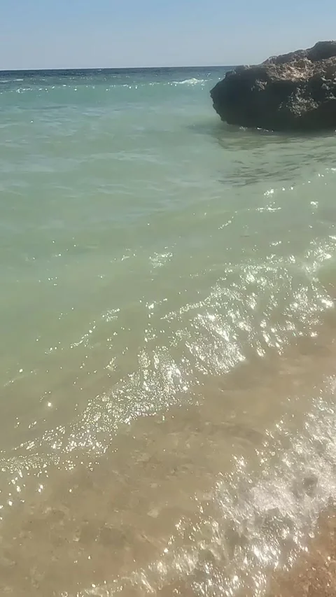 A Tranquil Dance of Waves and Foam Captured at the Seashore: Embracing the Stock Footage 332145835