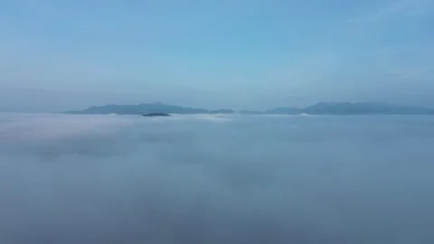 Tranquil Dawn Breaks Over a Mystical Landscape, Where Rolling Clouds Envelo.. 스톡 동영상 337270311