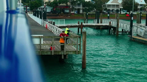 Tranquil Dockside Fishing: Man Angling by the Water Stock Footage 250140866