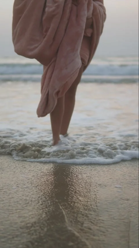 Tranquil Evening Beach Walk with Flowing Fabric and Serene Waves Stock Footage 320154716