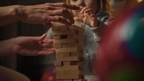 On tranquil evening at home mom child engage fun Jenka game on floor methodi Stock Footage 331300885