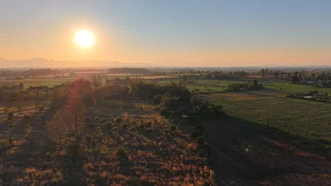 Tranquil Evening Landscape with Warm Sunlight and Mountain Backdrop Video stock 326176319