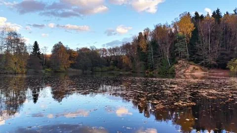 Tranquil evening lighting creates soothing atmosphere around calm reflective Stock Photos