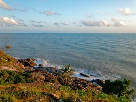 Tranquil fluffy cloud over the tropical beach at sunrise in Thailand Stock Photos