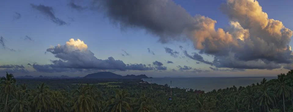 Tranquil fluffy cloud over the tropical mountain at sunrise in Thailand Stock Photos