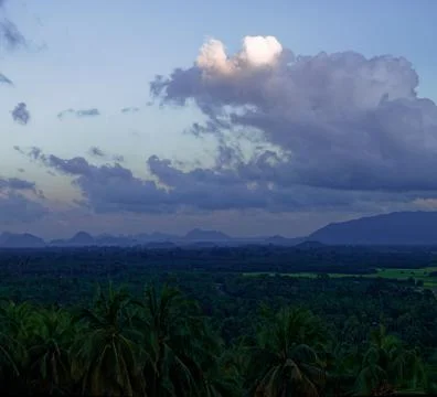 Tranquil fluffy cloud over the tropical mountain at sunrise in Thailand Stock Photos