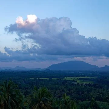 Tranquil fluffy cloud over the tropical mountain at sunrise in Thailand Stock Photos