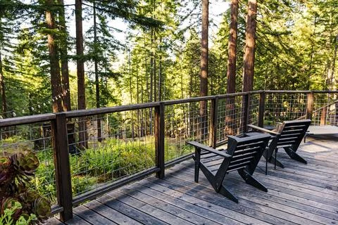 Tranquil Forest Deck with Chairs Stock Photos