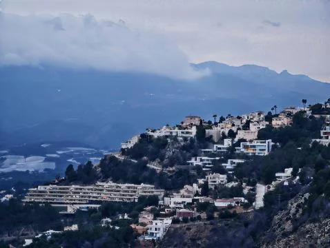 Tranquil Hilltop Community Overlooking Distant Waters With Charming Homes And Stock Photos