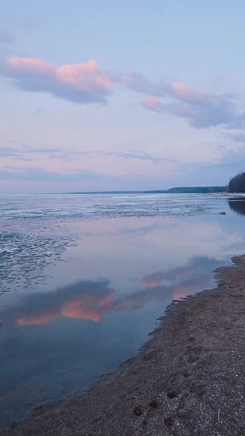 Tranquil Ice Floes at Sunset Over Calm Ocean Waters. Vertical video. Shot Stock Footage 310661719
