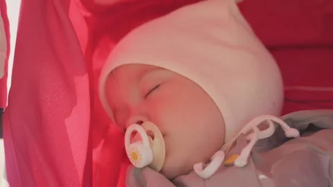 Tranquil infant peacefully sleeping under cozy clothing in stroller. Serene baby Video stock 330429677