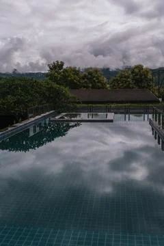 Tranquil infinity pool with forest and mountains in Pai, Thailand Stock Photos