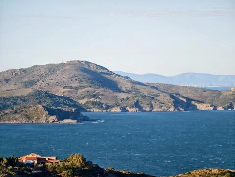 Tranquil Island Inlet Bordered By Smooth Hills And Soothing Aquatic Stock Photos
