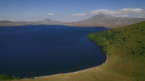 Tranquil Lake Aerial with Mountain Backdrop Stock Footage 256180663