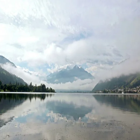 Tranquil Lake between the Alps Mountais and Forestin the Morning Stock Footage 69437020