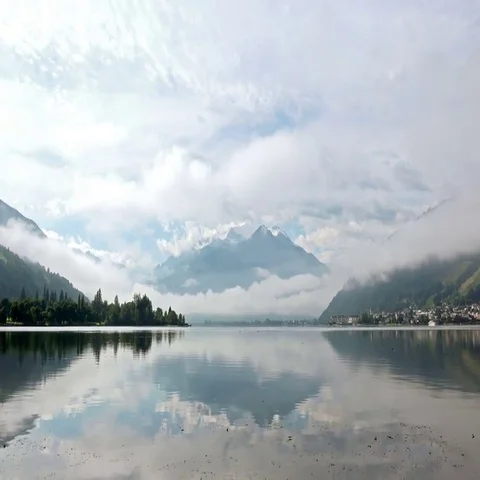 Tranquil Lake between the Alps Mountais and Forest in the Morning Stock Footage 69438171