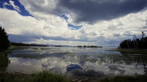 Tranquil Lake with Cloud Reflections Stock Footage 303941579