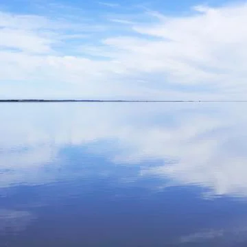 Tranquil lake with clouds reflecting Stock Photos