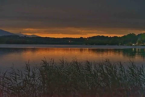 Tranquil Lake at Dusk with Sunset Reflection Stock Photos
