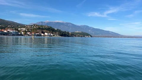 Tranquil lake journey with scenic mountain views under a clear blue sky Stock Footage 321069094