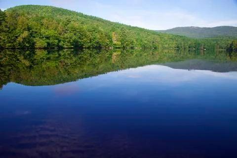 Tranquil lake with reflected mountain Stock Photos