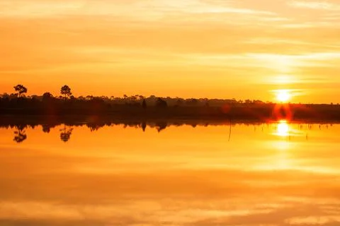 A tranquil lake at sunset. Stock Photos