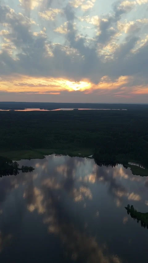 Tranquil Lake Surface and Stunning Sunset Sky on the Northern Horizon. Aerial Stockbeeldmateriaal 312804201
