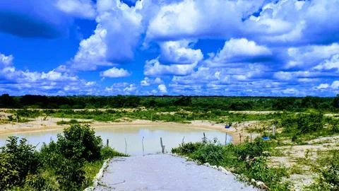 Tranquil Lake Under Dramatic Cloudy Sky in Remote Wilderness Stock Photos