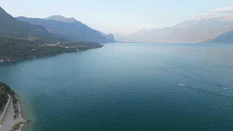 Tranquil Lake Waters and Hazy Mountains, Lake Garda, Drone Forward Shot Stock Footage 343682105