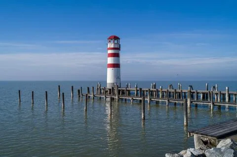 Tranquil Lakeside Lighthouse. Stock Photos