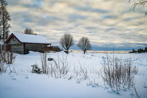 An tranquil landscape of cloud covered sky and snow covered lake in northern  Stock Photos