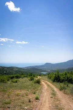 A tranquil landscape with the road going into the Stock Photos
