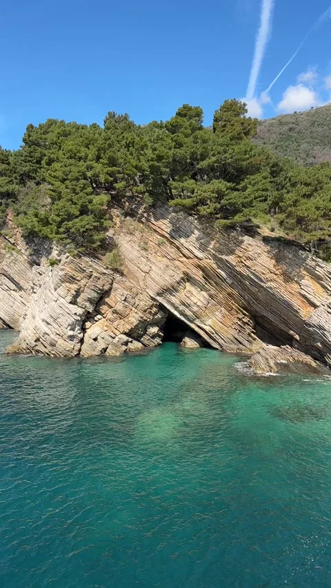 Tranquil landscape on a stratified rock and bright turquoise sea Stock Footage 277799200