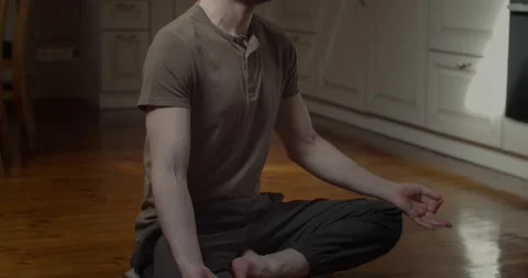 Tranquil man meditating in lotus pose alone at home background slow motion Stock Footage 151435862