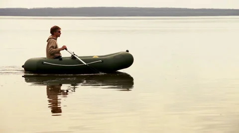 Tranquil man rowing in Inflatable boat on the quiet lake Stock-Footage 37169911
