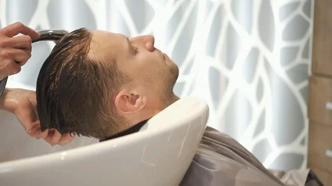 Tranquil man washing his head in spa salon Stock Footage 120406474