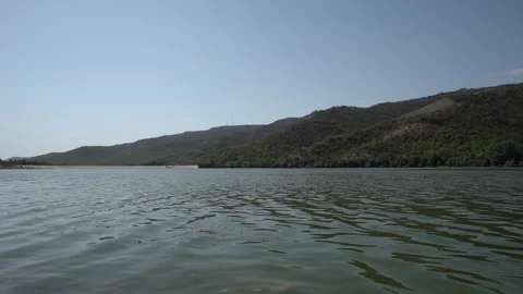 Tranquil Mountain Lake Surrounded by Forests Stock Footage 317911235