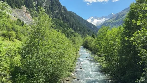 Tranquil Mountain River Flowing Through Austrian Alps Valley in Vibrant Sum.. Stock Footage 336192672