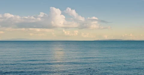Tranquil ocean and puffy clouds in the Coromandel Peninsula Stock Footage