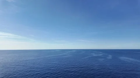 Tranquil Ocean Scene with Clear Blue Water and Softly Undulating Waves under Bri Stock Footage 283547886