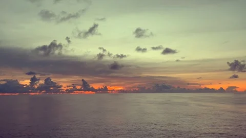 Tranquil ocean scene with dramatic cloudy sunset sky creating peaceful ambian Stock Footage 338280321