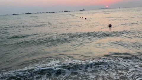 Tranquil Ocean Sunset with Pink Sky and Distant Ships Stock Footage 330855087
