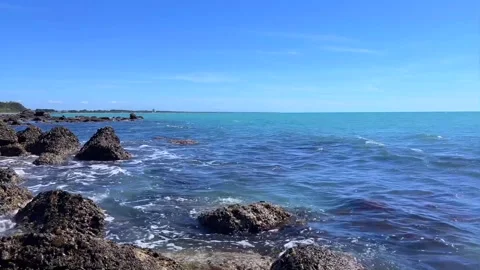 Tranquil ocean view with clear water and rocky coastline scene Stock Footage 310244580